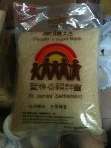 The Food Bank Repacks Rice in “St. James Settlement People’s Food Bank” Bags
